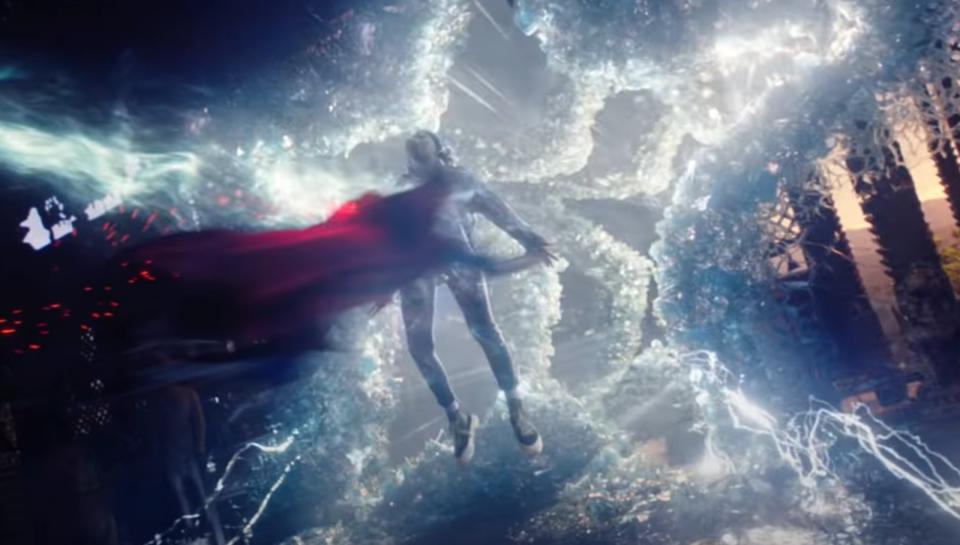 Doctor Strange (Benedict Cumberbatch) pushing America Chavez (Xochitl Gomez) through a star-shaped portal