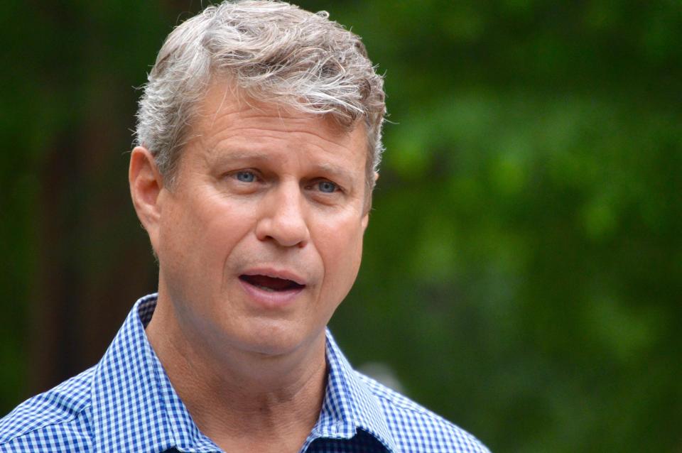 U.S. Rep. Bill Huizenga, R-Zeeland, speaks with a member of the media before the start of the "Back the Blue" event Saturday, Aug. 1, 2020, at Centennial Park in Holland, Mich.