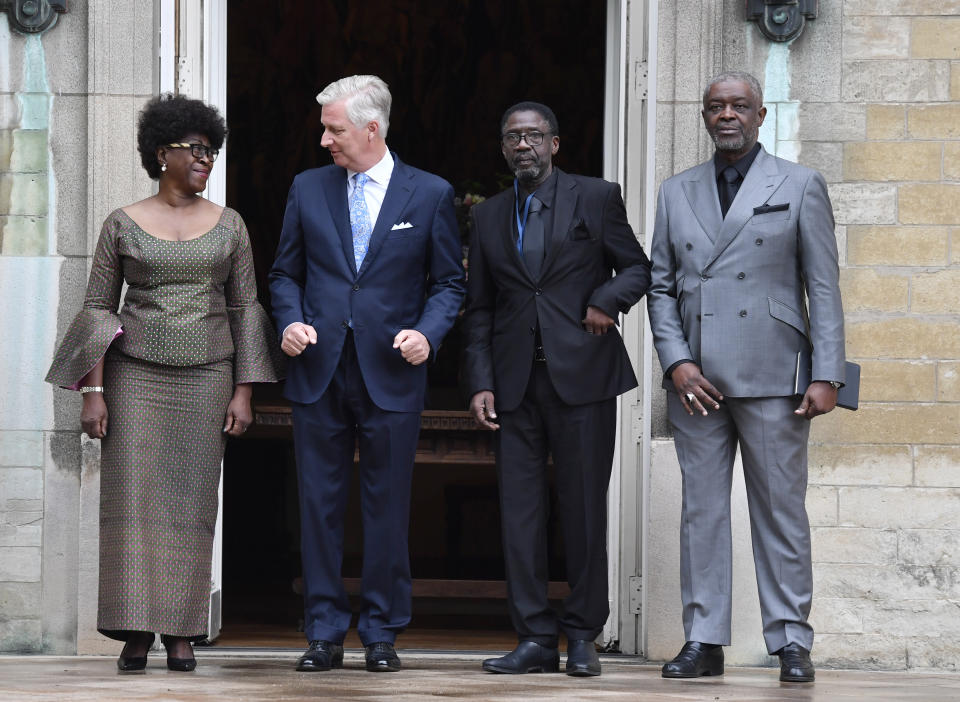 Belgium's King Philippe, second left, greets the children of Congo's former prime minister Patrice Lumumba, from left, Juliana, Francois and Roland at the Royal Palace in Brussels, Monday, June 20, 2022. On Monday, more than sixty one years after his death, the remains of Congo's first democratically elected prime minister Patrice Lumumba will be handed over to his children during an official ceremony in Belgium. (AP Photo/Geert Vanden Wijngaert)