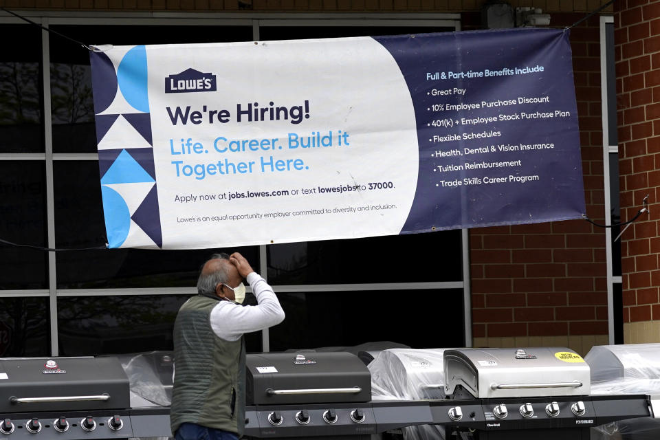 A hiring sign is displayed at a home improvement store in Northbrook, Ill., Thursday, May 5, 2022. America’s employers added 428,000 jobs in April, extending a streak of solid hiring that has defied punishing inflation, chronic supply shortages, the Russian war against Ukraine and much higher borrowing costs. (AP Photo/Nam Y. Huh)