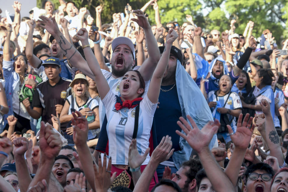 Argentina's soccer fans react as they watch their team's soccer match against Mexico at the World Cup, hosted by Qatar, in Buenos Aires, Argentina, Saturday, Nov. 26, 2022. (AP Photo/Gustavo Garello)