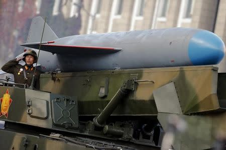 A soldier salutes from atop vehicle carrying a missile past a stand with North Korean leader Kim Jong Un during the parade celebrating the 70th anniversary of the founding of the ruling Workers' Party of Korea, in Pyongyang October 10, 2015. REUTERS/Damir Sagolj