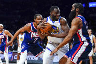 Brooklyn Nets' James Harden, right, and Kevin Durant (7) defend against Golden State Warriors' Draymond Green (23) during the first half of an NBA basketball game Tuesday, Nov. 16, 2021 in New York. (AP Photo/Frank Franklin II)