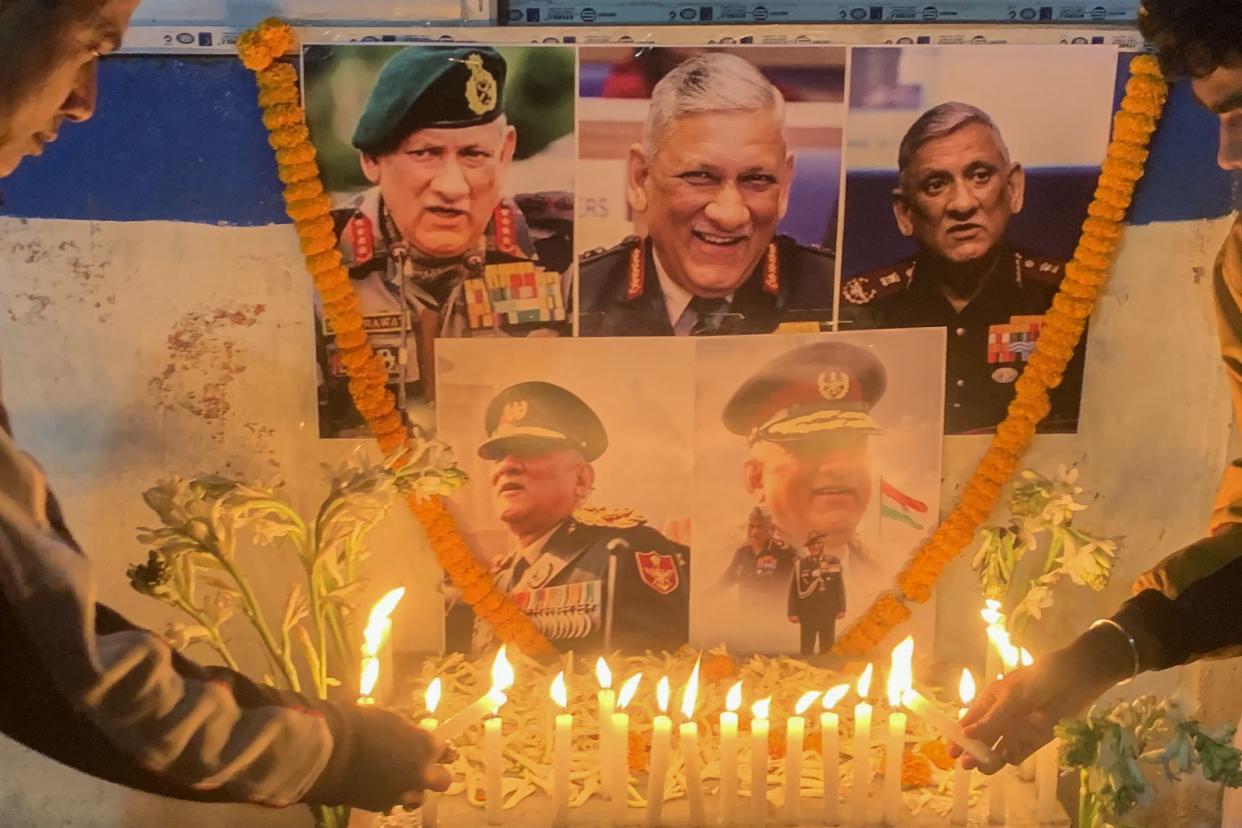 People light candles to pay their respect in front of a portrait of defence chief General Bipin Rawat in Siliguri on Wednesday. (Photo by Diptendu DUTTA / AFP) (Photo by DIPTENDU DUTTA/AFP via Getty Images)