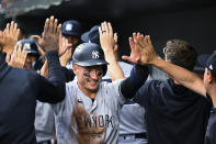 New York Yankees' Josh Donaldson is greeted in the dugout by teammates after scoring a run on a wild pitch during the first inning of a baseball game against the Baltimore Orioles on Wednesday, May 18, 2022, in Baltimore. (AP Photo/Terrance Williams)