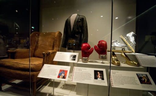 Muhammad Ali's boxing gloves from his 1974 defeat of champion George Foreman for the world Heavyweight title are displayed as part of the Smithsonian Mueseum of American History's new exhibition showcasing stories about the American experience