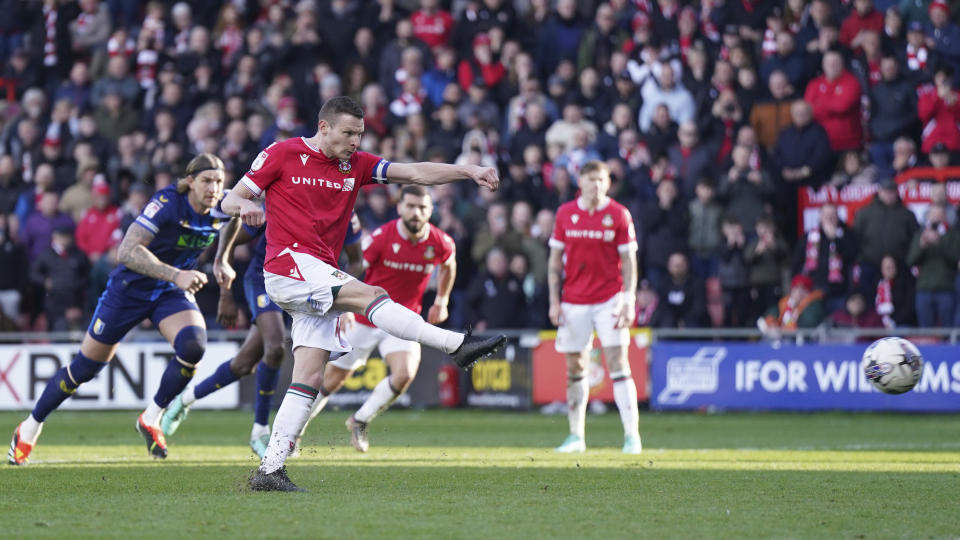 Wrexham's Paul Mullin scores their side's second goal from the penalty spot during the English League Two soccer match between Wrexham and Mansfield Town at the SToK Cae Ras in Wrexham, Wales, Friday, March 29, 2024. (Jacob King/PA via AP)