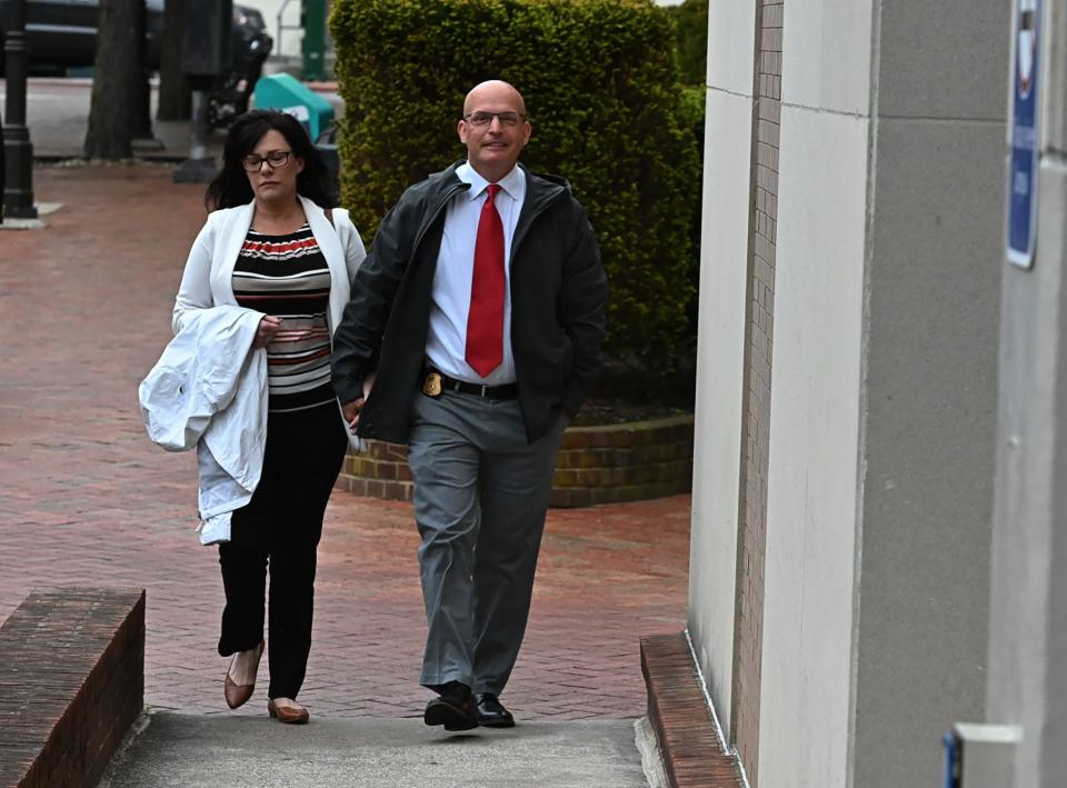 Maryland State Police Detective Sgt. Phil Martin and his wife, Teresa, walk into Washington County Circuit Court on Tuesday morning for the hearing of Joe Esquivel, who killed three workers at Columbia Machine in Smithsburg.  Martin was wounded in a shoot-out with Esquivel after he fled his workplace.