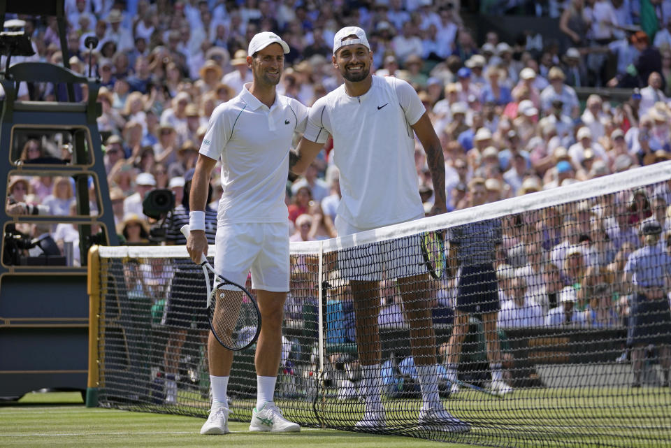 Australia's Nick Kyrgios, right, and Serbia's Novak Djokovic pose for a photo at the net before the final of the men's singles on day fourteen of the Wimbledon tennis championships in London, Sunday, July 10, 2022. (AP Photo/Alastair Grant)