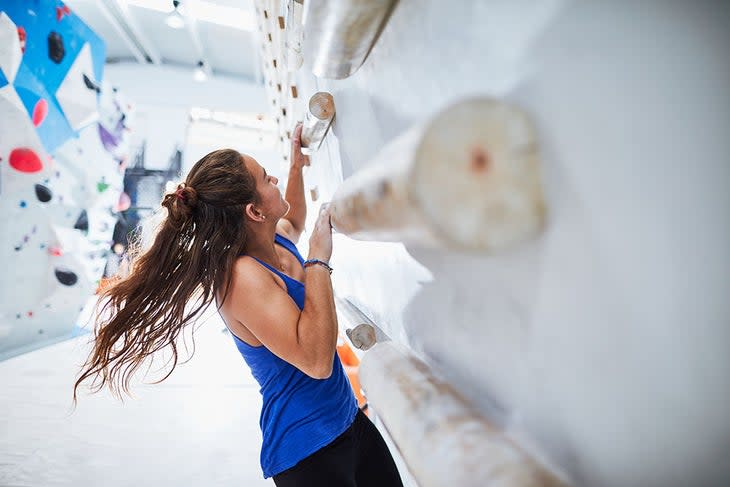 Climber training on a campus board.