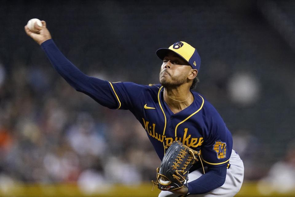 Milwaukee Brewers starting pitcher Freddy Peralta throws a pitch against the Arizona Diamondbacks during the first inning of a baseball game Tuesday, June 22, 2021, in Phoenix. (AP Photo/Ross D. Franklin)