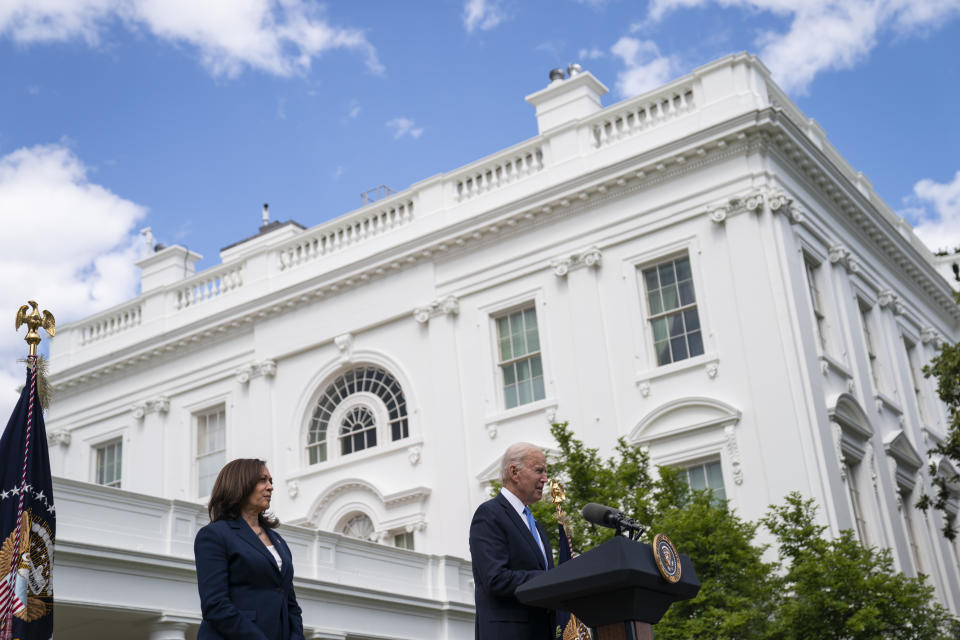 FILE - In this May 13, 2021, file photo Vice President Kamala Harris listens as President Joe Biden speaks about updated guidance on mask mandates, in the Rose Garden of the White House in Washington. Thanks to growing availability of the coronavirus vaccine and a recent relaxation of federal guidance on masks and distancing, the Biden administration is embracing the look and feel of pre-pandemic days on Pennsylvania Avenue. (AP Photo/Evan Vucci, File)