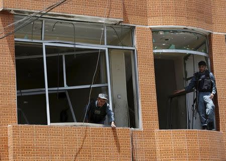 Afghan police keep watch at the site of a suicide attack in Kabul, Afghanistan July 7, 2015. REUTERS/Ahmad Masood