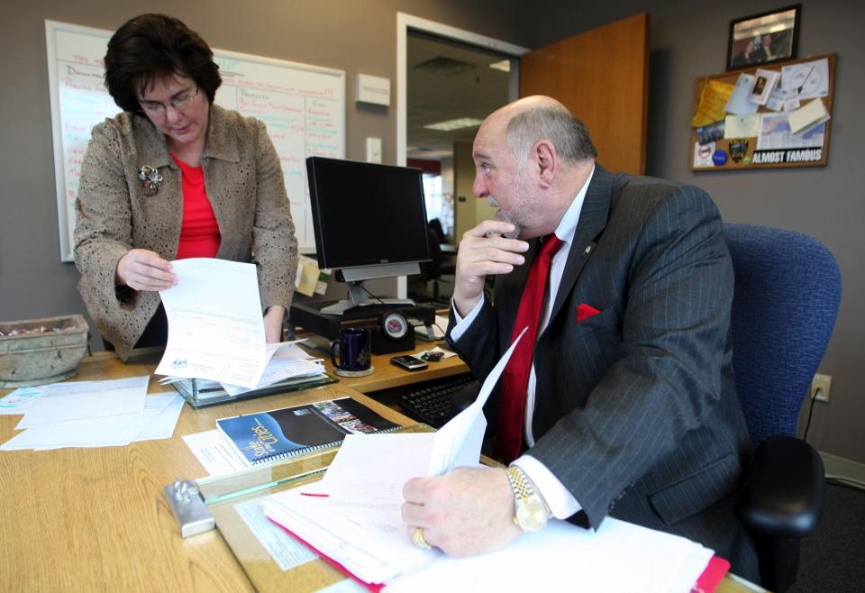 Coppola discusses bills with city clerk Patti Fitzpatrick at his office in Port Orchard in 2009.