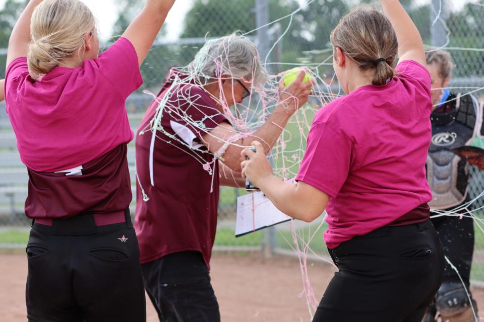 Morenci softball coach Kay Johnson gets covered in silly string after getting win No. 1,000 for the Bulldogs.