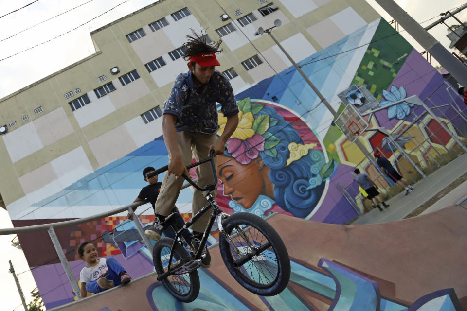 Manuel Enrique Rivera practices freestyle on his BMX bike in a recreational area of the Mejicanos municipality of San Salvador province, El Salvador, Sunday, March 19, 2023. One year ago, President Nayib Bukele suspended constitutional rights and started an all-out offensive on gangs, triggering a radical transformation in some of the country’s most dangerous areas where many Salvadorans enjoy new freedoms like being outside at night, delivery services and open businesses without gangs extorting them for money. (AP Photo/Salvador Melendez)
