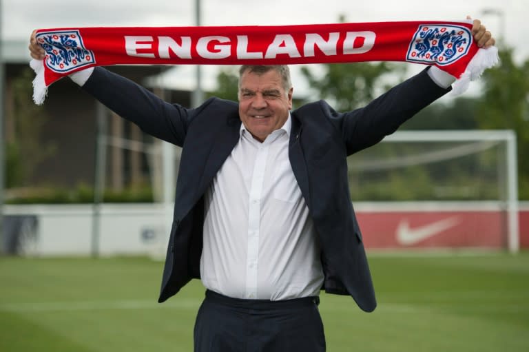 Sam Allardyce holds up an England scarf during a photocall at St George's Park, shortly after his appointment as England's football coach, on July 25, 2016