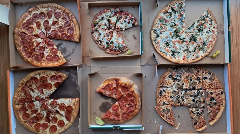 Six pizzas missing a slice