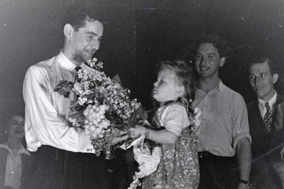 Leonard Bernstein receives flowers from an admirer after conducting an orchestra of concentration camp survivors for a concert sponsored by the American Jewish Joint Distribution Committee on May 10, 1948, outside Munich.