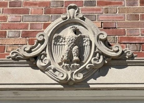 Close-up view of the eagle cartouche above the front entrance at the Two Rivers Post Office.