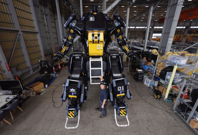 CEO Ryo Yoshida poses for a photograph with ARCHAX, a giant human-piloted robot, in Yokohama, Japan