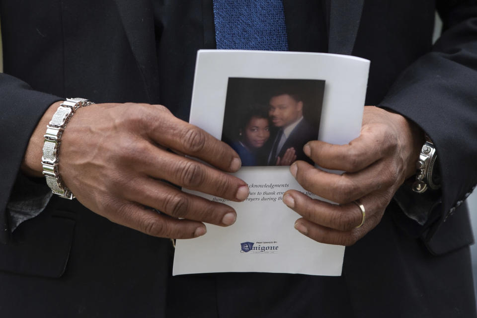 A person holds a program for the funeral service for Aaron Salter Jr. at The Chapel on Crosspoint on Wednesday, May 25, 2022, in Getzville, N.Y. Salter Jr. was killed in the Buffalo supermarket shooting on May 14. (AP Photo/Joshua Bessex)