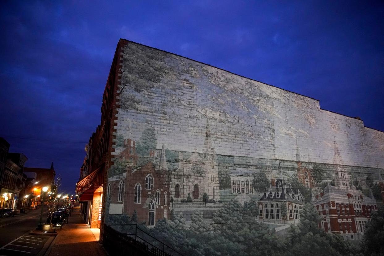 A mural of Clarksville before the 1999 tornado tore through downtown sits contrasted against the empty sky and sidewalks on Franklin Street in Clarksville, Tenn., on Tuesday, March 31, 2020. 