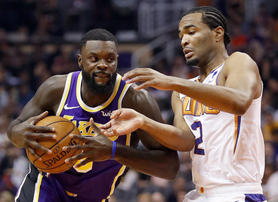 Los Angeles Lakers guard Lance Stephenson drives past Phoenix Suns guard Elie Okobo (2) during the first half of an NBA basketball game, Wednesday, Oct. 24, 2018, in Phoenix. (AP Photo/Matt York)