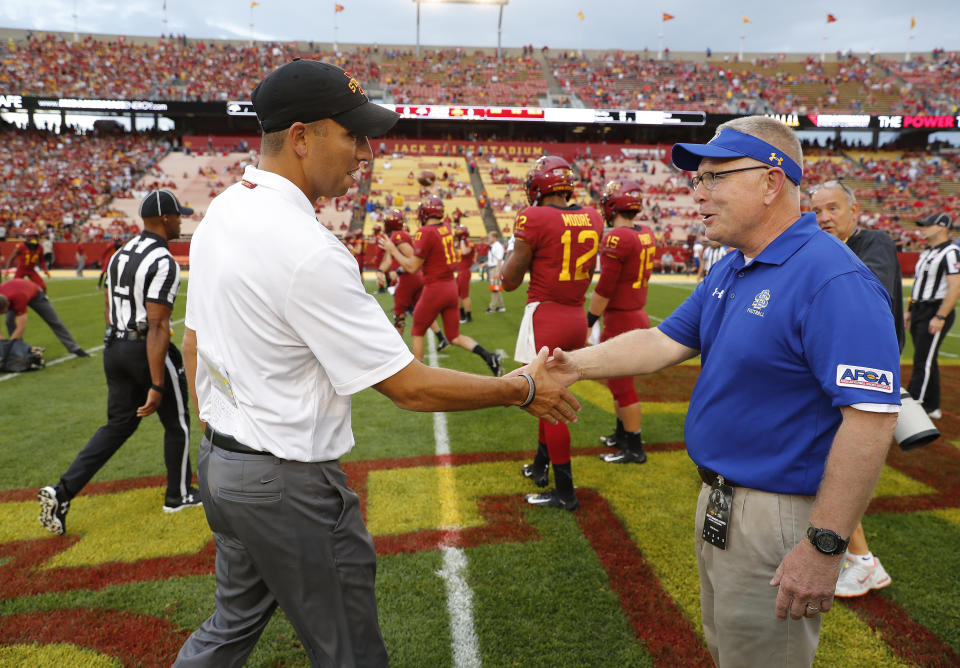 Iowa State head coach Matt Campbell, left, shakes hands with South Dakota State head coach John Stiegelmeier, before the NCAA college football game, Saturday, Sept. 1, 2018, in Ames, Iowa. (AP Photo/Matthew Putney)