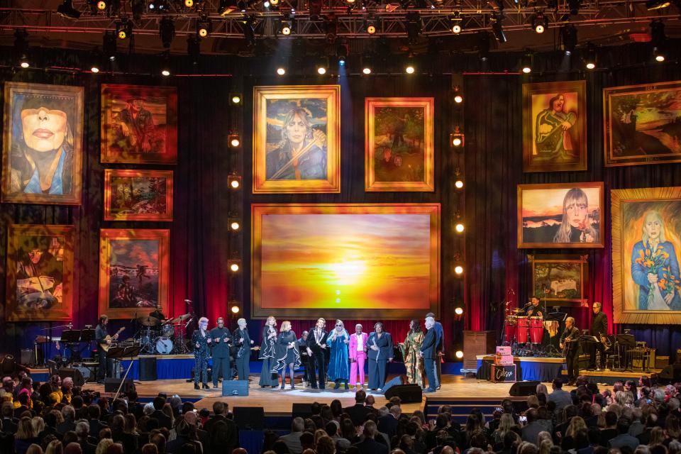 Joni Mitchell was surrounded by fellow performers (from L) Cyndi Lauper, Herbie Hancock, Annie Lennox, Holly Laessig, Jess Wolf, Brandi Carlile, Angelique Kidjo, Celisse, Ledisi, James Taylor and Graham Nash as they performed "The Circle Game."