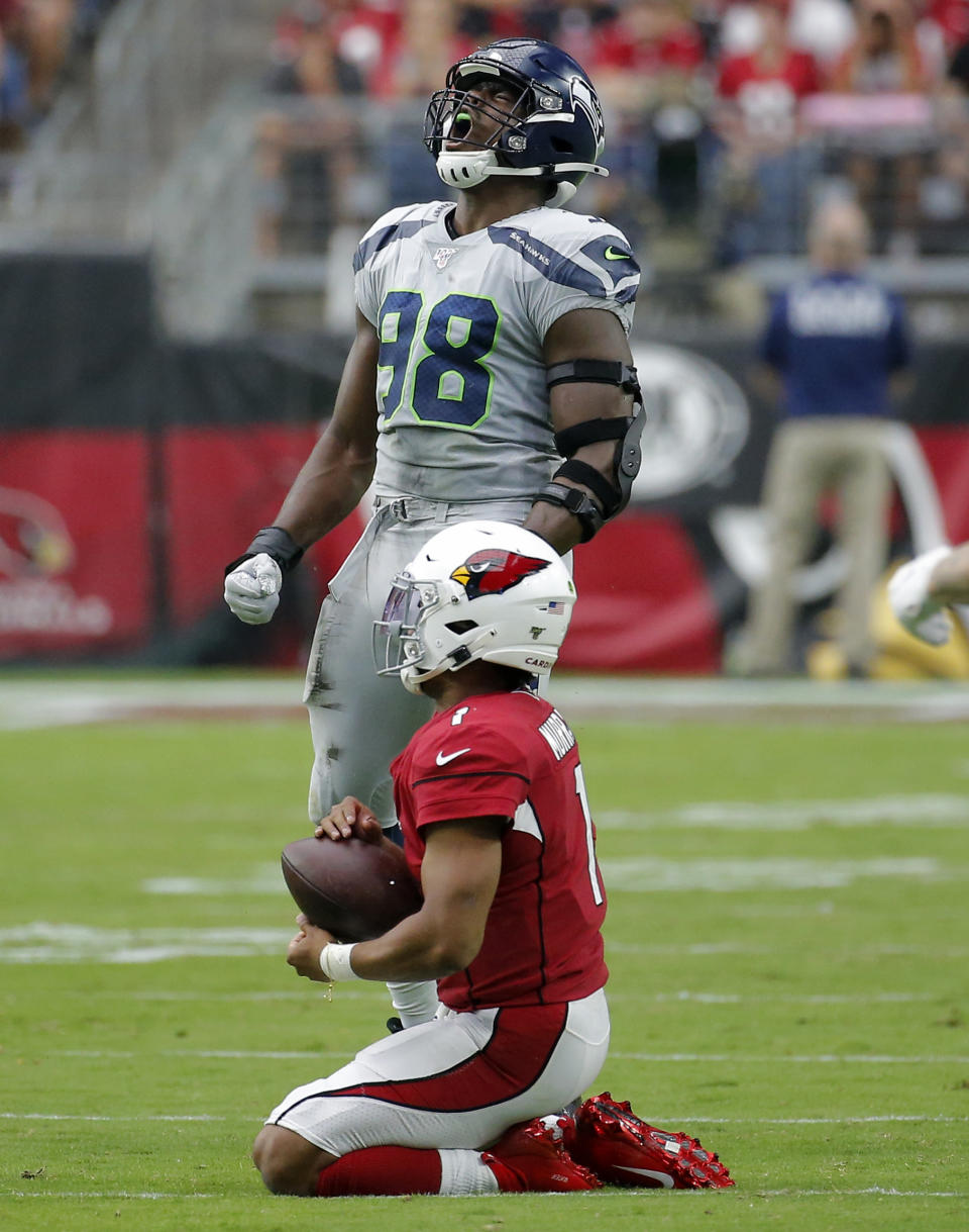 Arizona Cardinals quarterback Kyler Murray (1) kneels on the turf after being tackled by Seattle Seahawks defensive end Rasheem Green (98) during the first half of an NFL football game, Sunday, Sept. 29, 2019, in Glendale, Ariz. (AP Photo/Rick Scuteri)