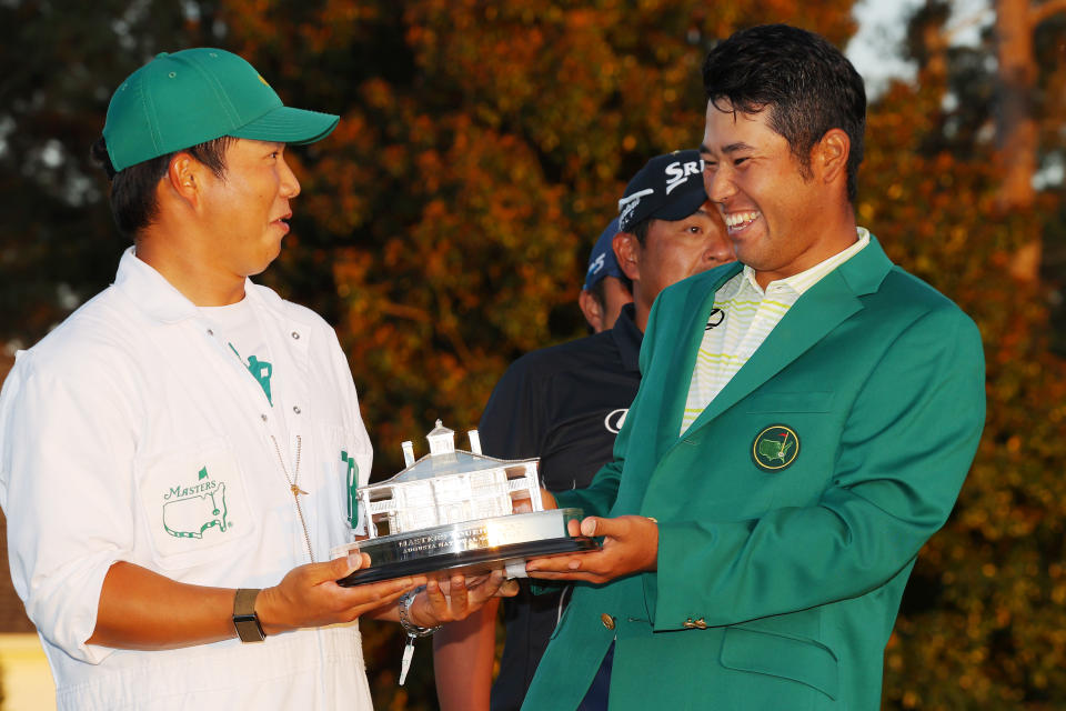 AUGUSTA, GEORGIA - APRIL 11: Hideki Matsuyama of Japan poses with his caddie, Shota Hayafuji, and the Masters Trophy during the Green Jacket Ceremony after winning the Masters at Augusta National Golf Club on April 11, 2021 in Augusta, Georgia. (Photo by Kevin C. Cox/Getty Images)