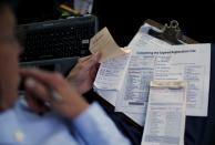 A Retired Senior Volunteer Patrol member fills out expired registration paperwork while on patrol in San Diego, California, United States March 10, 2015. (REUTERS/Mike Blake)