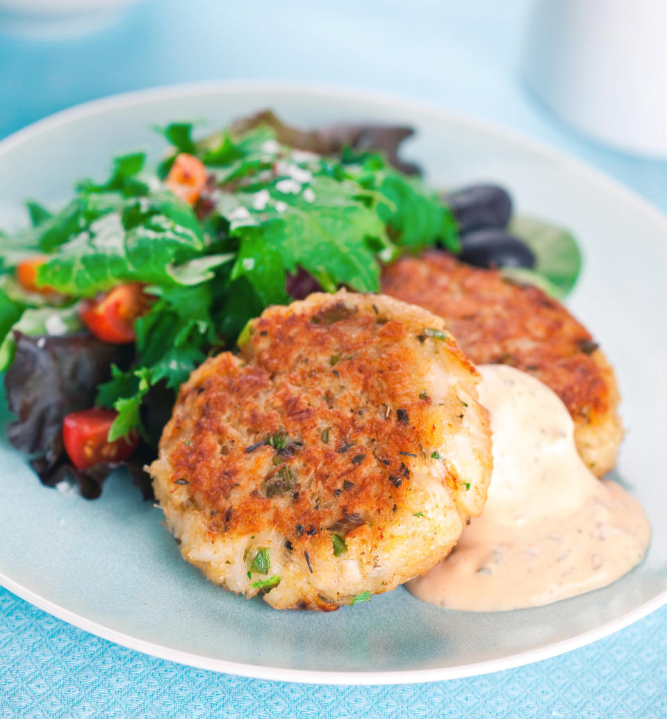 Crab cakes served with a side salad.