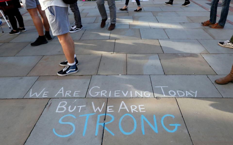 A message is written on the pavement in Manchester - Credit: AP Photo/Kirsty Wigglesworth