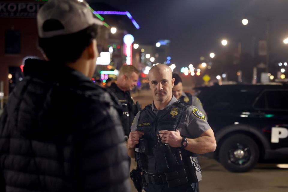 Master Sgt. Grimes informs a young person Dec. 22 of the curfew in Bricktown.