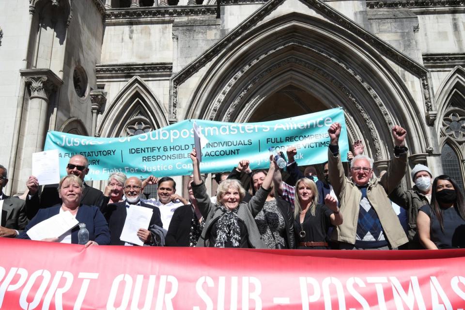 Former Post Office workers celebrate outside the Royal Courts of Justice, London, after having their convictions overturned by the Court of Appeal (PA)