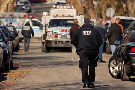 Police gather outside a house in the Brooklyn borough, while they investigate an earlier incident of the reported explosion at the New York Port Authority Bus Terminal in Manhattan, in New York City, New York, U.S. December 11, 2017. REUTERS/Lucas Jackson