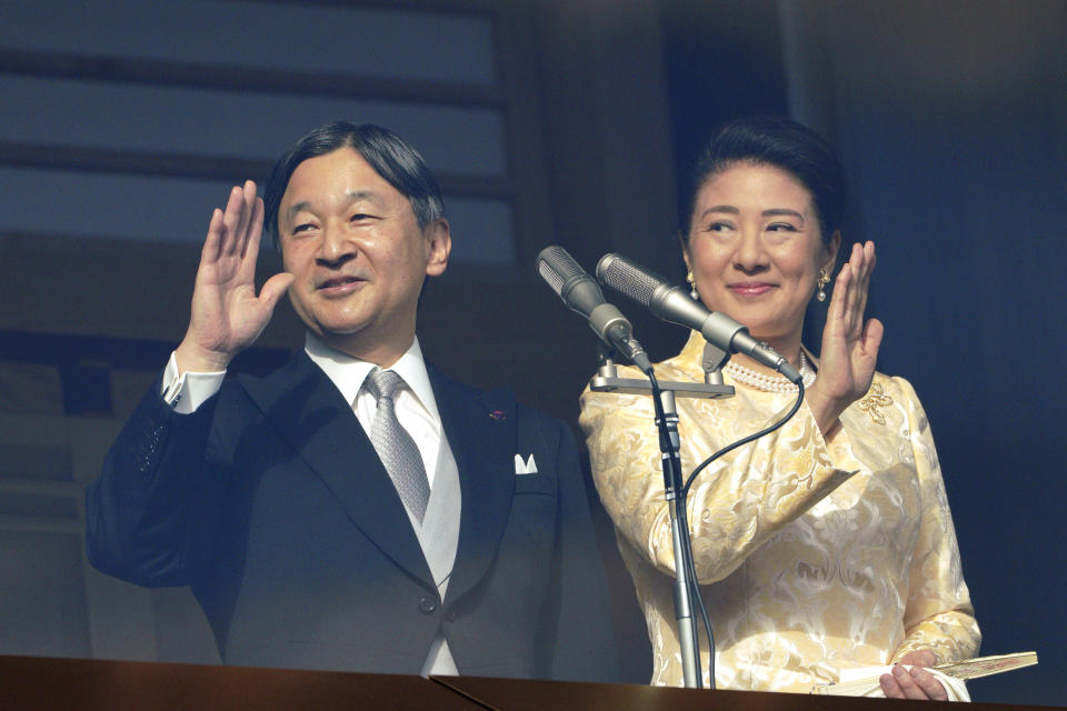 Japan's Emperor Naruhito waves with Empress Masako to well-wishers from the bullet-proofed balcony during a public appearance with his imperial families at Imperial Palace in Tokyo Thursday, Jan. 2, 2020, in Tokyo. (AP Photo/Eugene Hoshiko)
