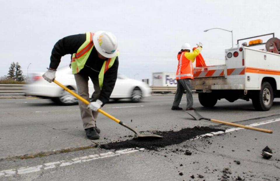 Caltrans workers fill a pothole on the Capital City Freeway. If you see a pothole developing within Sacramento County or city limits, call 311 to request a repair.
