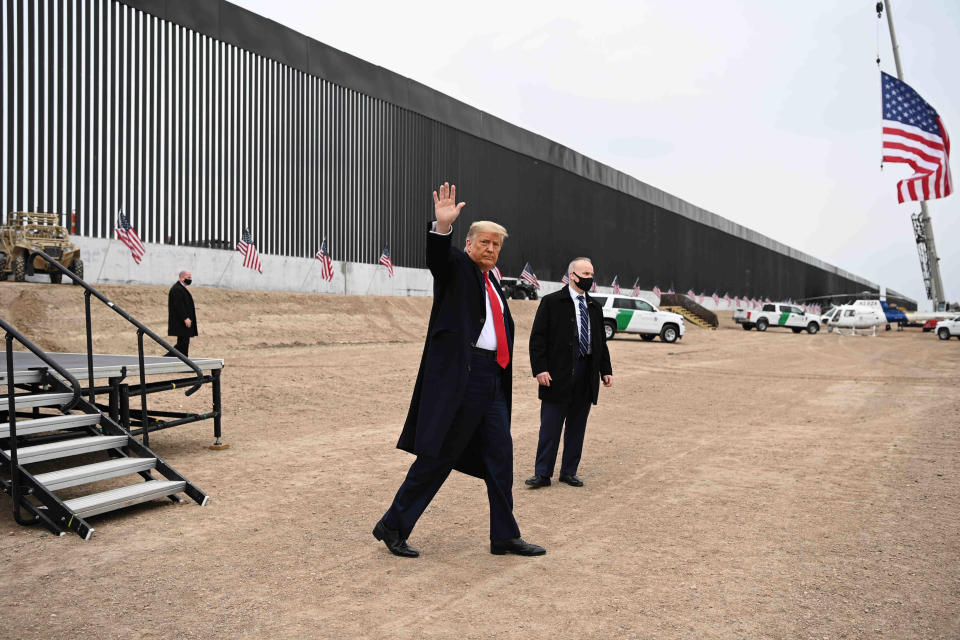 Former President Donald Trump waves after touring a section of the border wall in South Texas in 2021.