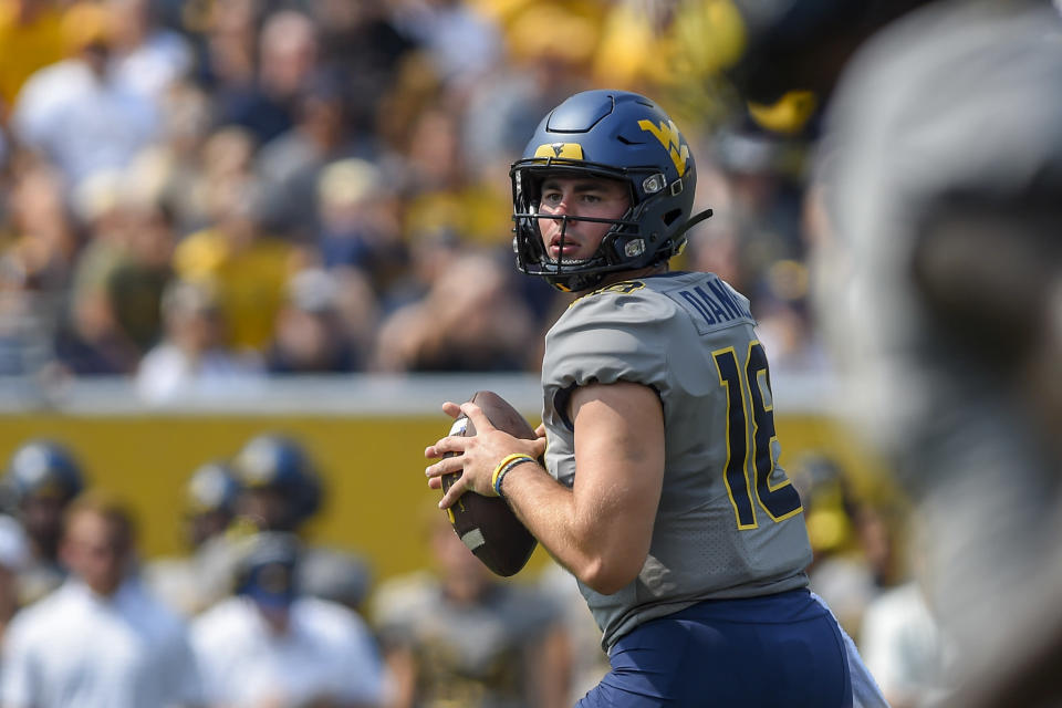 West Virginia quarterback JT Daniels (18) looks to pass against Towson during the first half of an NCAA college football game in Morgantown, W.Va., Saturday, Sept. 17, 2022. (AP Photo/William Wotring)