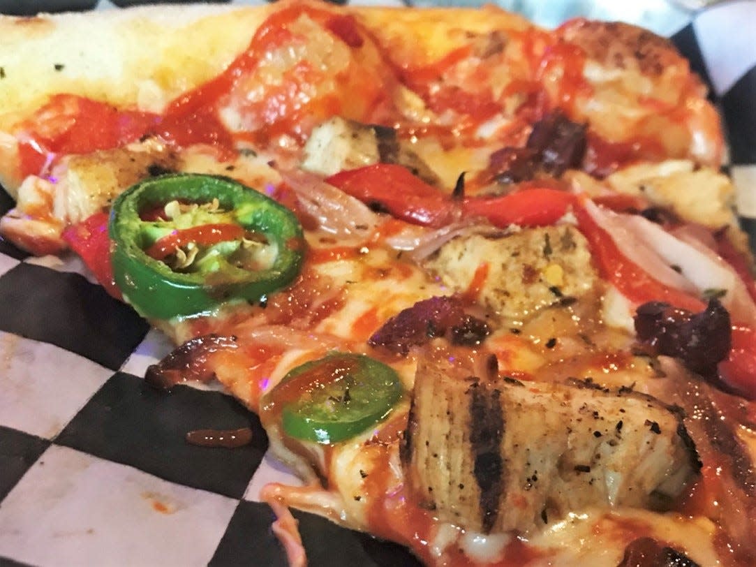 Fresh jalapenos, grilled chicken, red onions and more on this specialty slice from Rendezvous Pizza in downtown Oklahoma City.