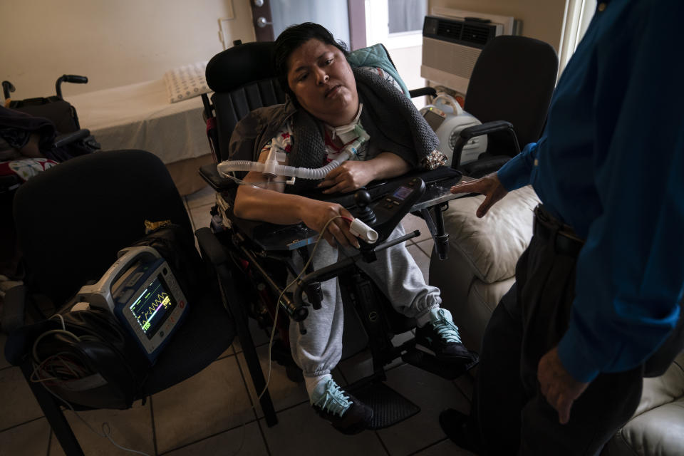 A blood oxygen monitor is attached to Socorro Franco-Martinez, who has muscular dystrophy, after she received the second dose of the Pfizer COVID-19 vaccine at her apartment, Wednesday, May 12, 2021, in Torrance, Calif. Teamed up with the Torrance Fire Department, Torrance Memorial Medical Center started inoculating people at home in March, identifying people through a city hotline, county health department, senior centers and doctor's offices, said Mei Tsai, the pharmacist who coordinates the program. (AP Photo/Jae C. Hong)