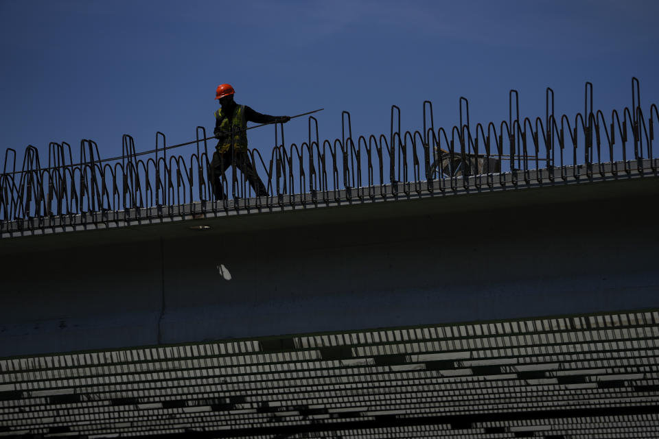 A worker loads a steel cable at a construction site in Beijing, Monday, June 17, 2024. China's central bank kept a key lending rate unchanged on Monday, choosing not to loosen credit as data for May showed signs of persisting weakness in manufacturing and the real estate sector. (AP Photo/Andy Wong)