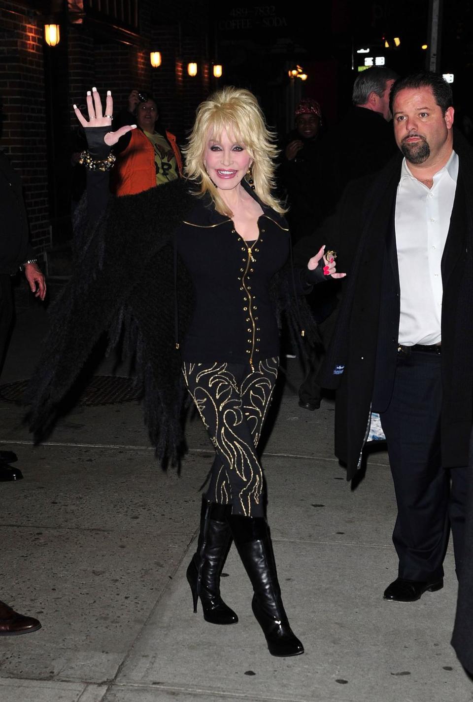 <p>We don't see Dolly wearing this color often, but when she does, she makes sure to do so with her bedazzled flair. A fringe jacket, gold jewelry, and black pants with gold designs ensure she is as glitzy as ever—even in black. </p>