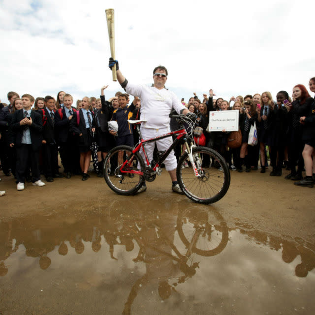 DanJarvis carries the Olympic Flame at the mountain bike course at Hadleigh Farm