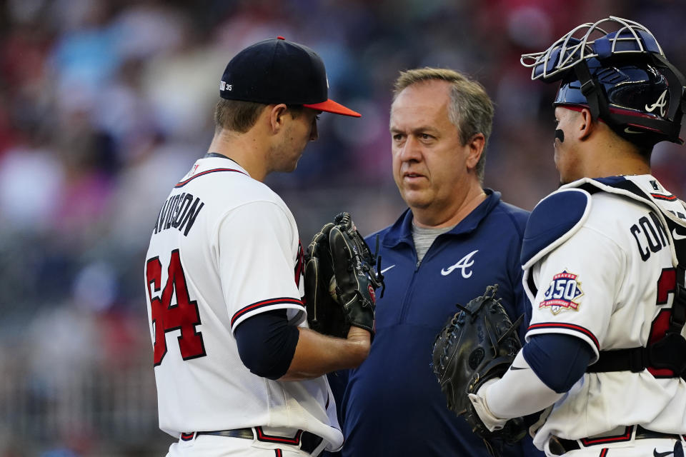 Atlanta Braves starting pitcher Tucker Davidson (64) talks to a member of the medical staff before leaving the team's baseball game against the Boston Red Sox during the third inning Tuesday, June 15, 2021, in Atlanta. (AP Photo/John Bazemore)