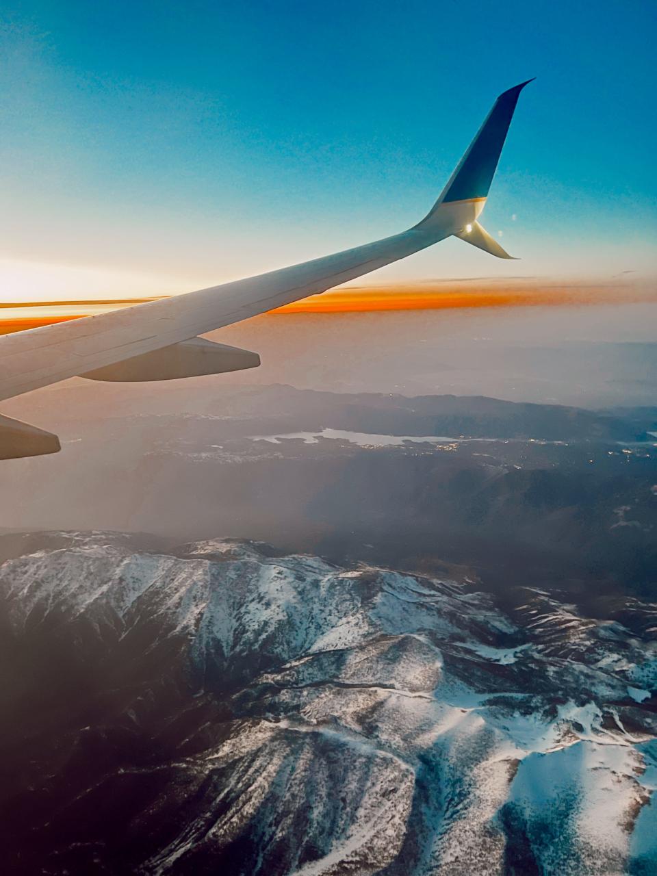 view of snowcapped mountains from airplane window