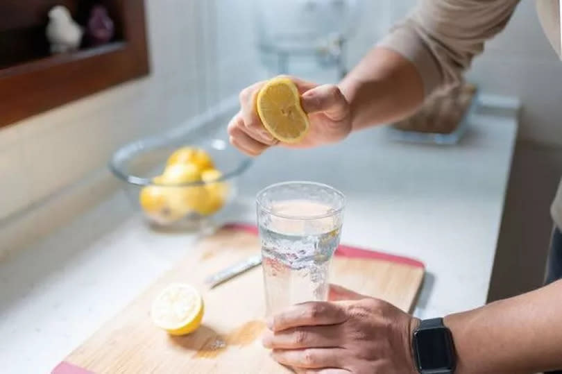 Man Squeezing Out Juice Of Lemon